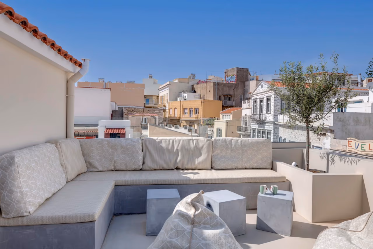 Built-in seating and olive tree on the upper terrace in daylight