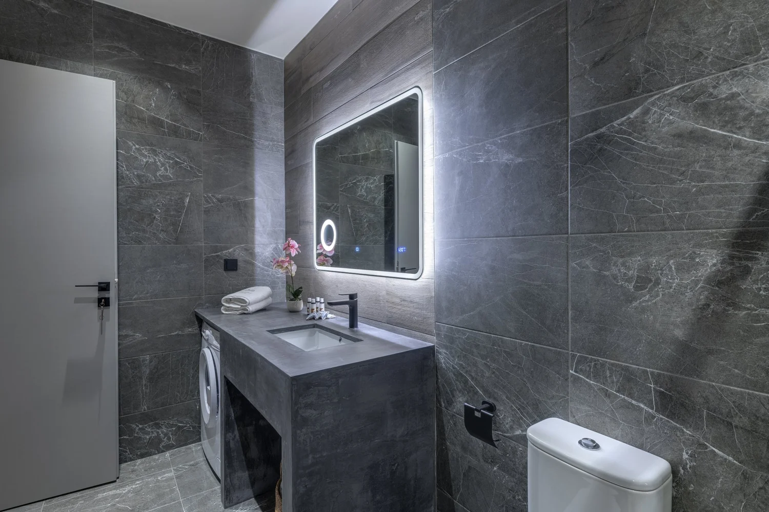 Bathroom with washing machine and storage