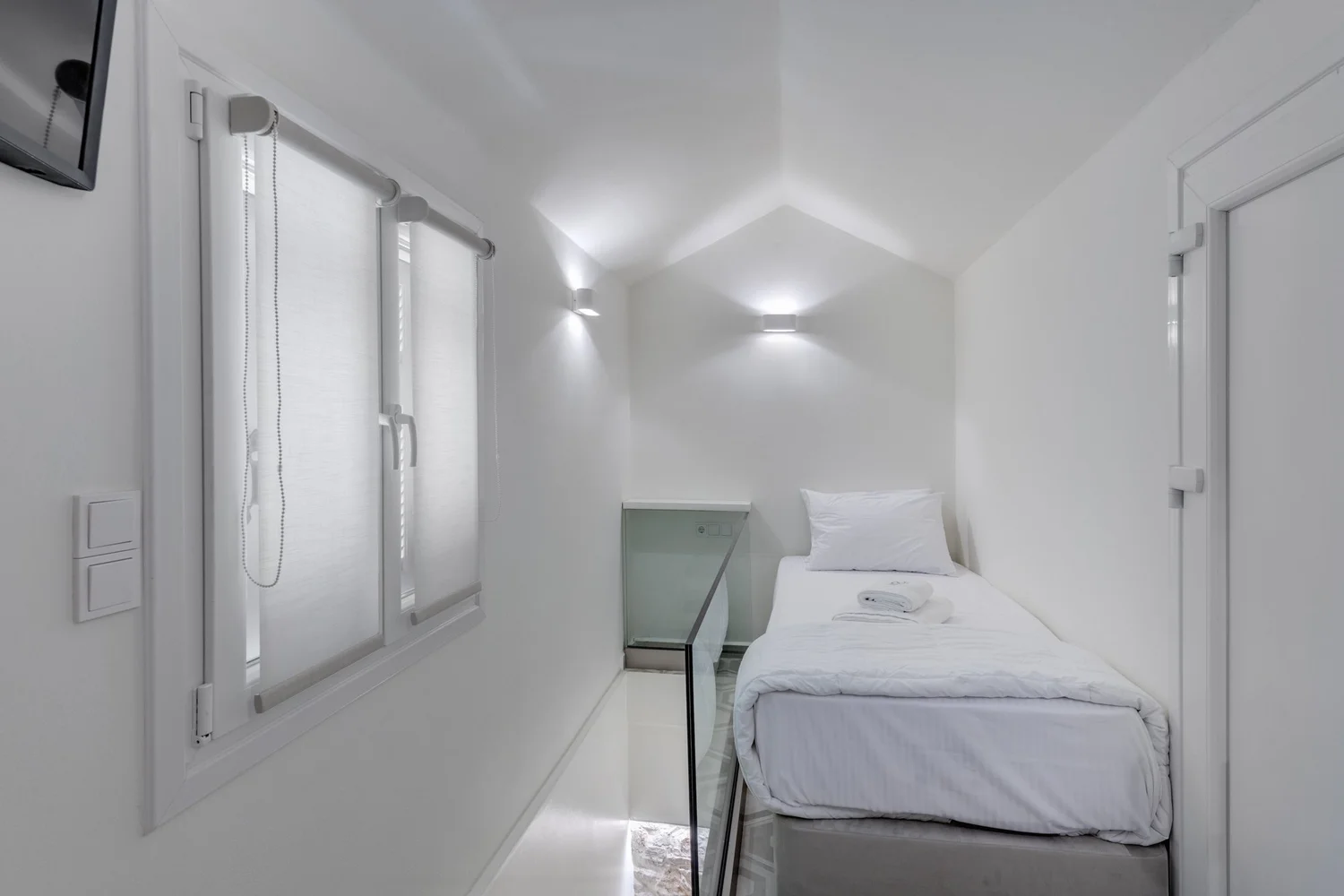 Bedroom three with its single bed and soft lighting