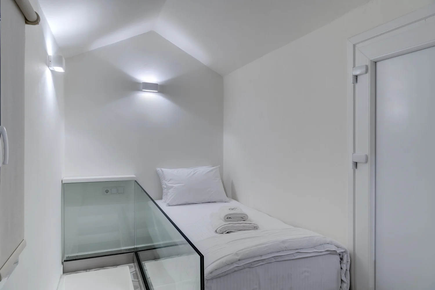 Bedroom three with white linen and soft lighting