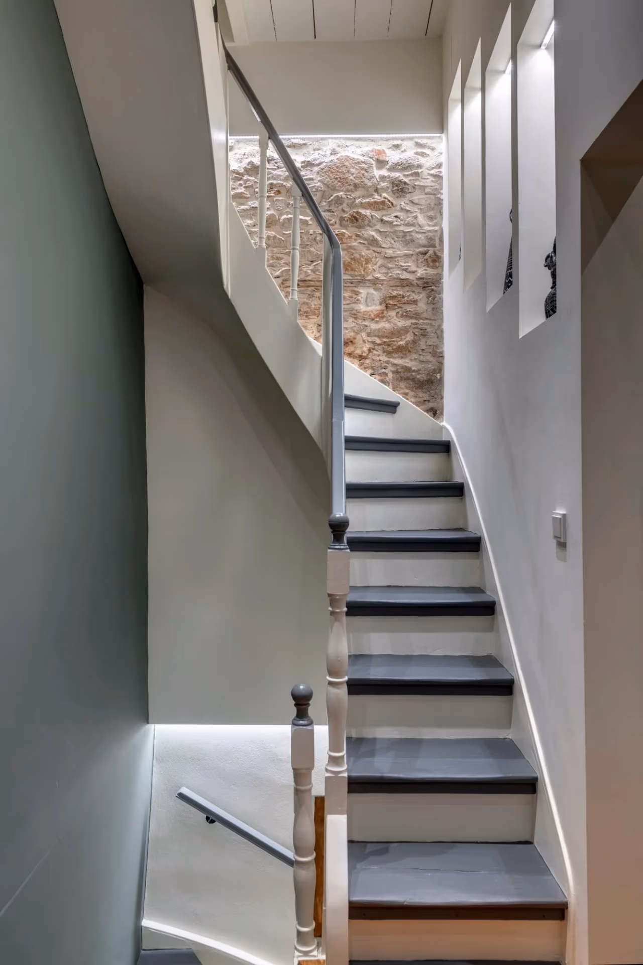 Curved interior staircase with exposed stonework