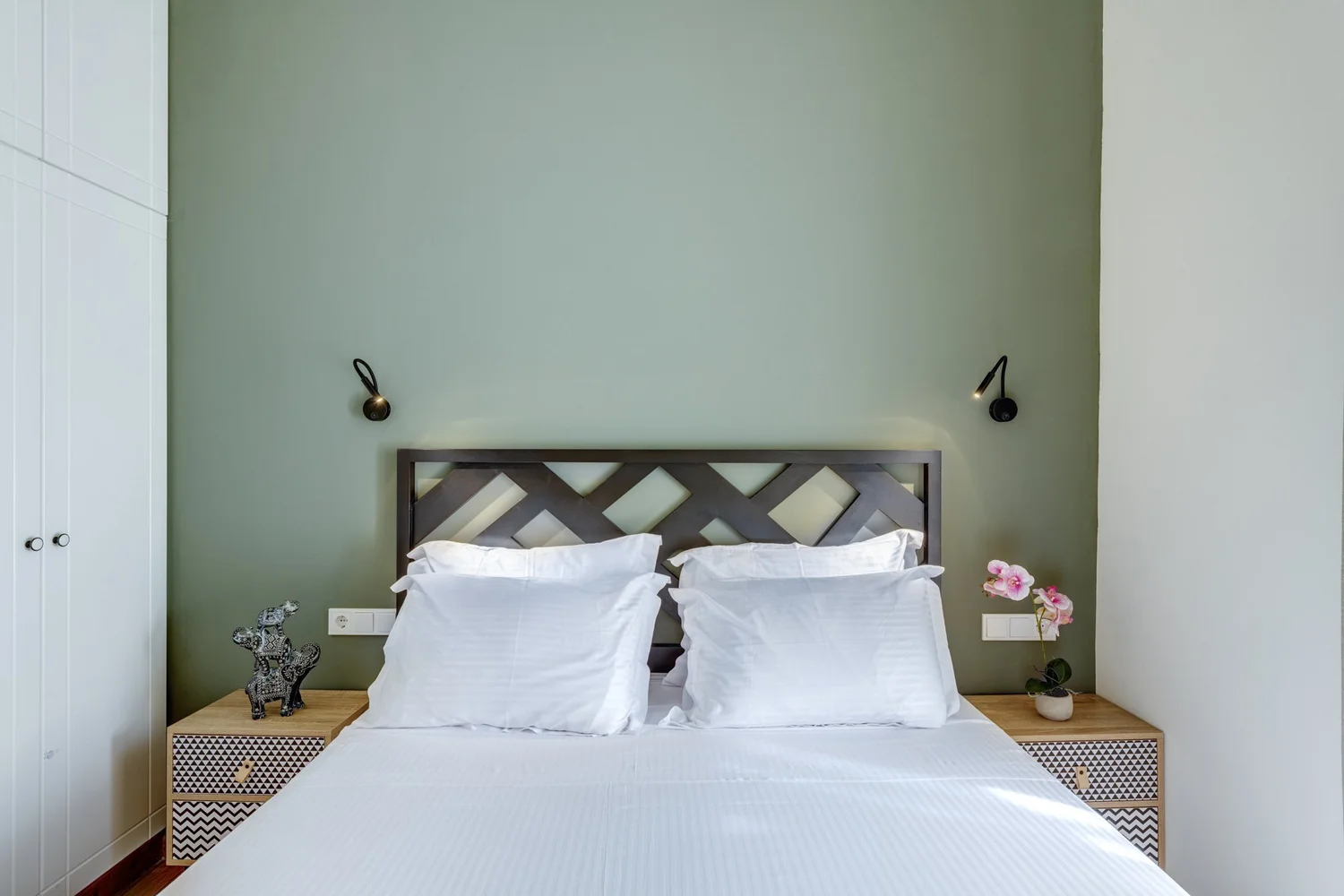 Bedroom one with its timber headboard and reading lights