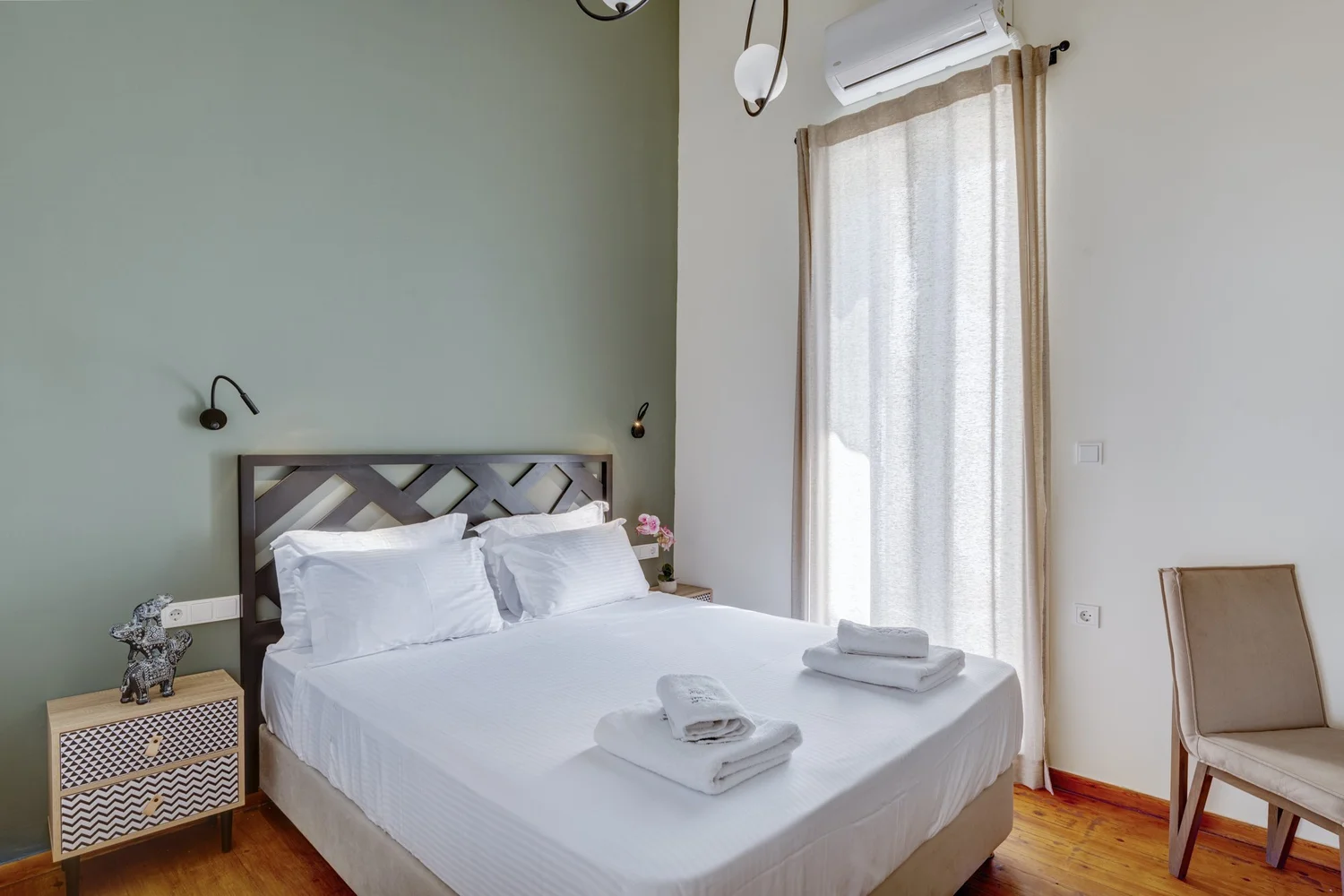 Bedroom one with a green accent wall